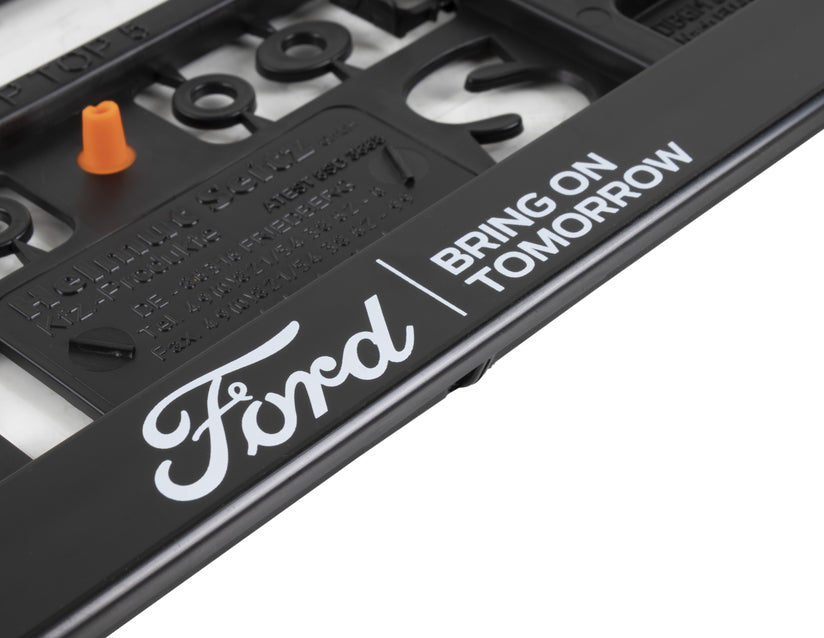 Genuine Ford Licence Plate Holder black, with blue Ford logo and white "BRING ON TOMORROW" lettering