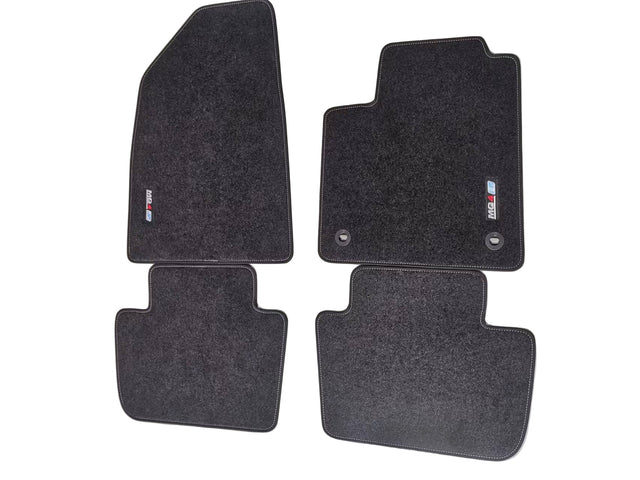 A set of black fabric floor mats with an embroidered logo, designed for a MG4 EV vehicle.